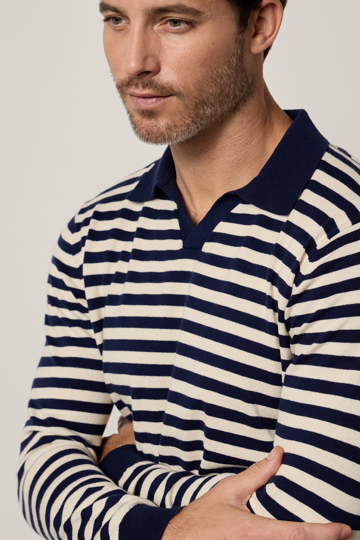   a man wearing a RICKY STRIPED POLO by Velvet by Graham & Spencer. 
