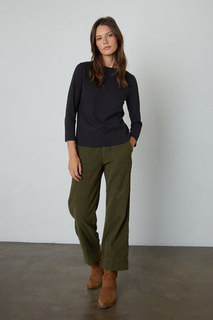 Quinny 3/4 Sleeve Mock Neck Tee in black with Vera Pant in Aloe and brown boots front view