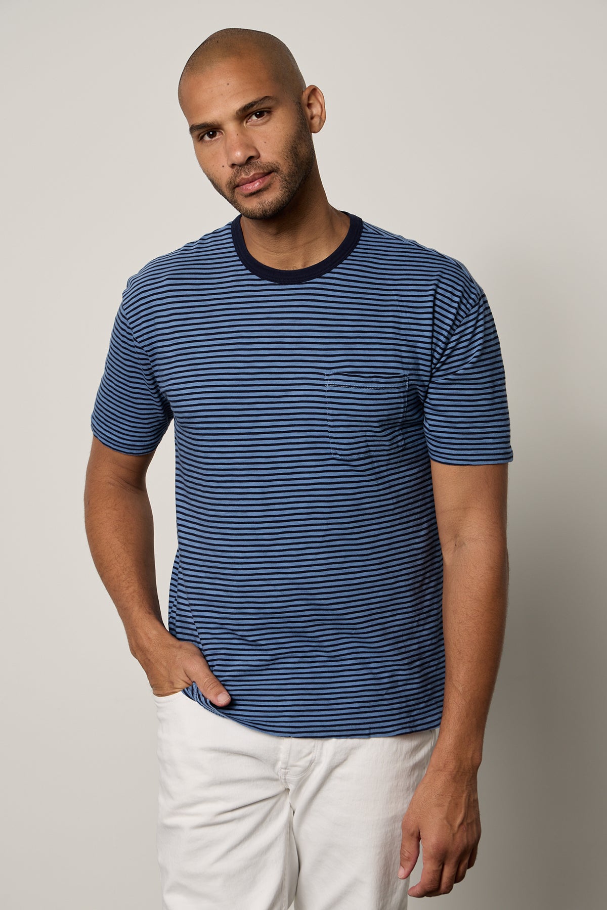 Jeremy Crew Neck Tee with medium and dark blue stripes, front pocket, paired with white denim front-26249323970753