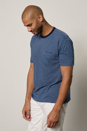 Jeremy Crew Neck Tee with medium and dark blue stripes, front pocket, paired with white denim front & side