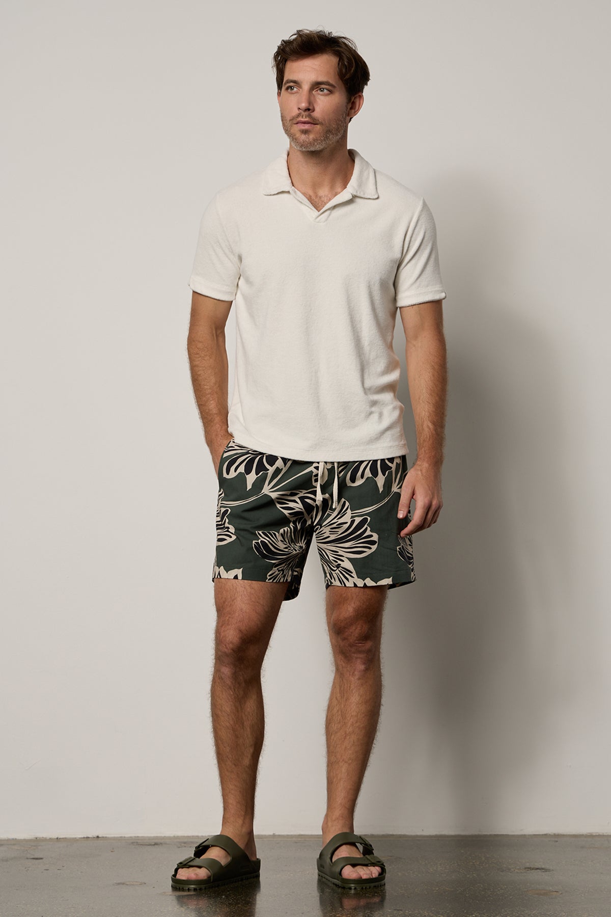   Colt Short front in catalina print with bold, black and cream pattern on dark green background with Boris Polo in ecru, full length front with Birkenstocks 