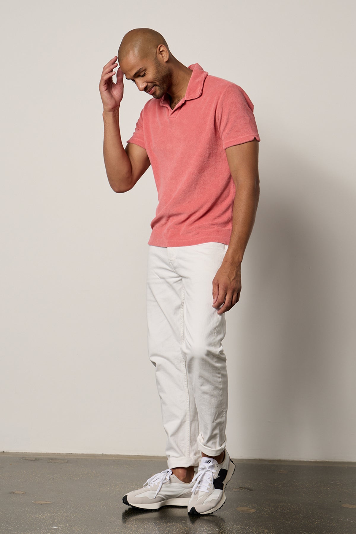   a man wearing a BORIS TERRY POLO polo shirt and white pants from Velvet by Graham & Spencer. 
