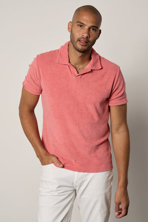 a man wearing a Velvet by Graham & Spencer BORIS TERRY POLO shirt and white pants.