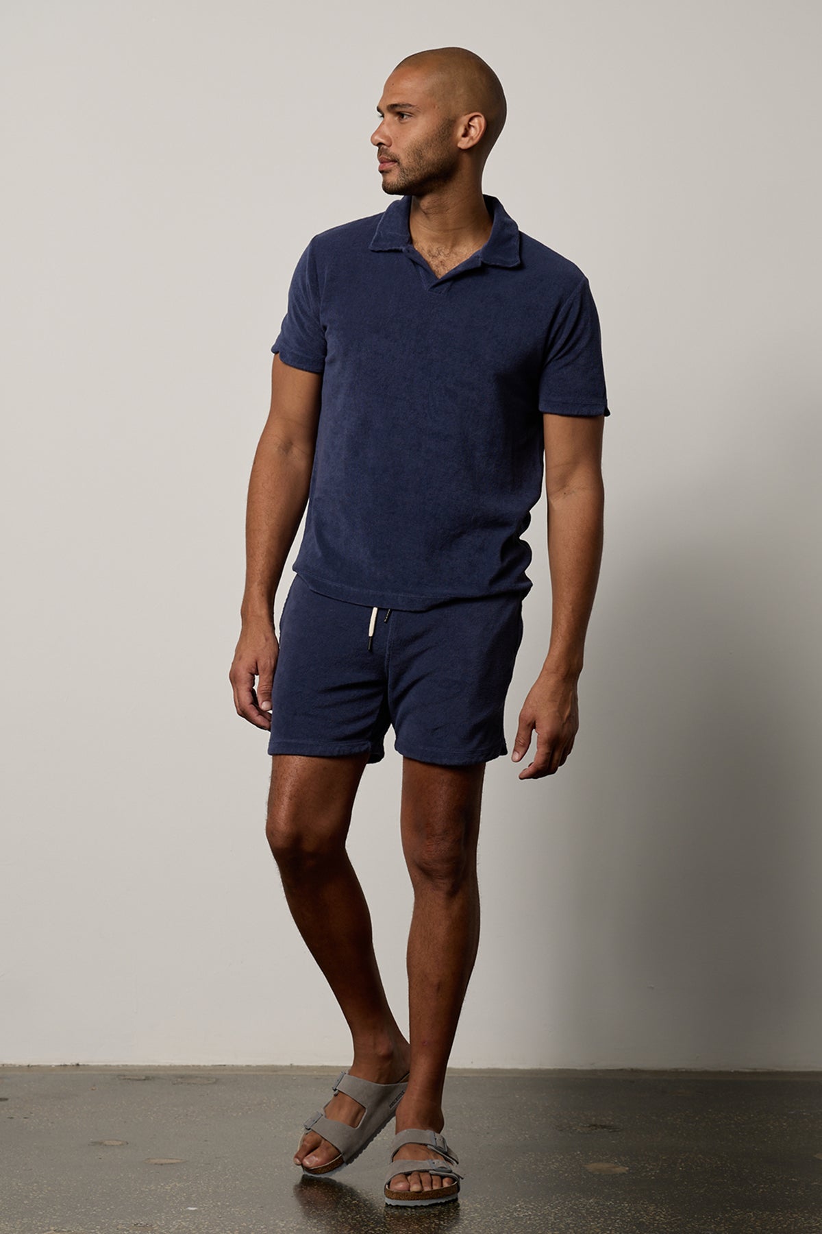   A man wearing a Velvet by Graham & Spencer OZZIE TERRY SHORT in navy. 