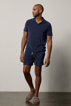 A man wearing a Velvet by Graham & Spencer OZZIE TERRY SHORT in navy.