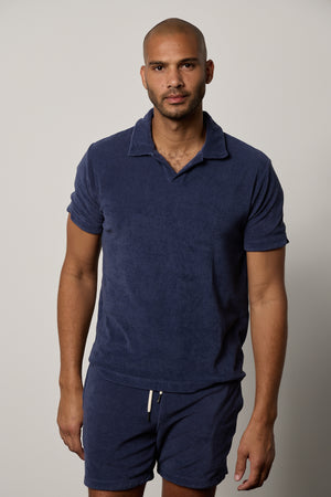 a man wearing the Velvet by Graham & Spencer BORIS TERRY POLO shirt and shorts.