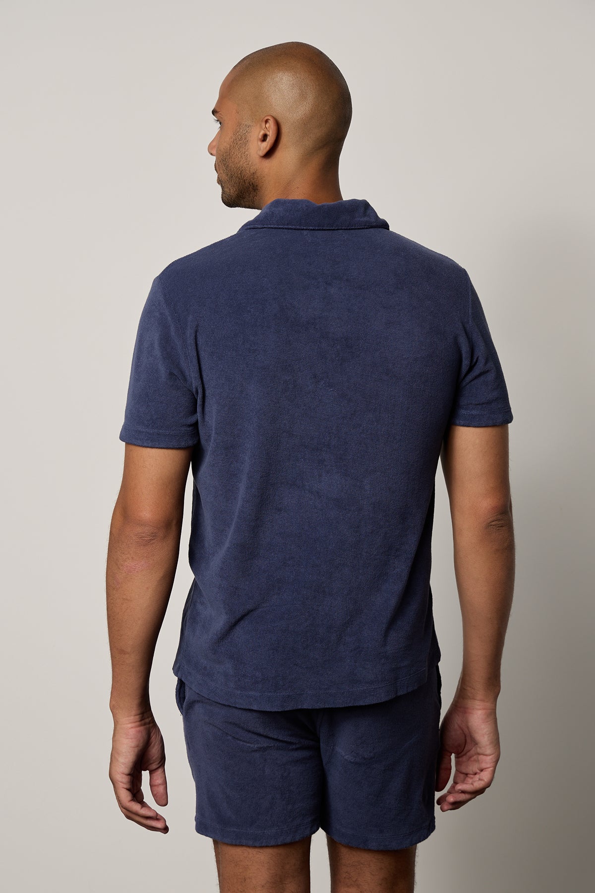the back view of a man wearing Velvet by Graham & Spencer's BORIS TERRY POLO and shorts.-26266324533441