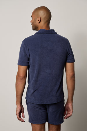 the back view of a man wearing Velvet by Graham & Spencer's BORIS TERRY POLO and shorts.