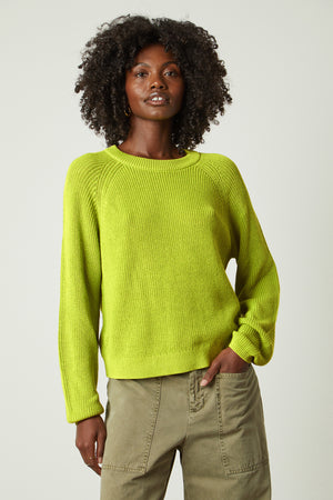 a woman wearing a Velvet by Graham & Spencer LINAH CREW NECK SWEATER and khaki pants.