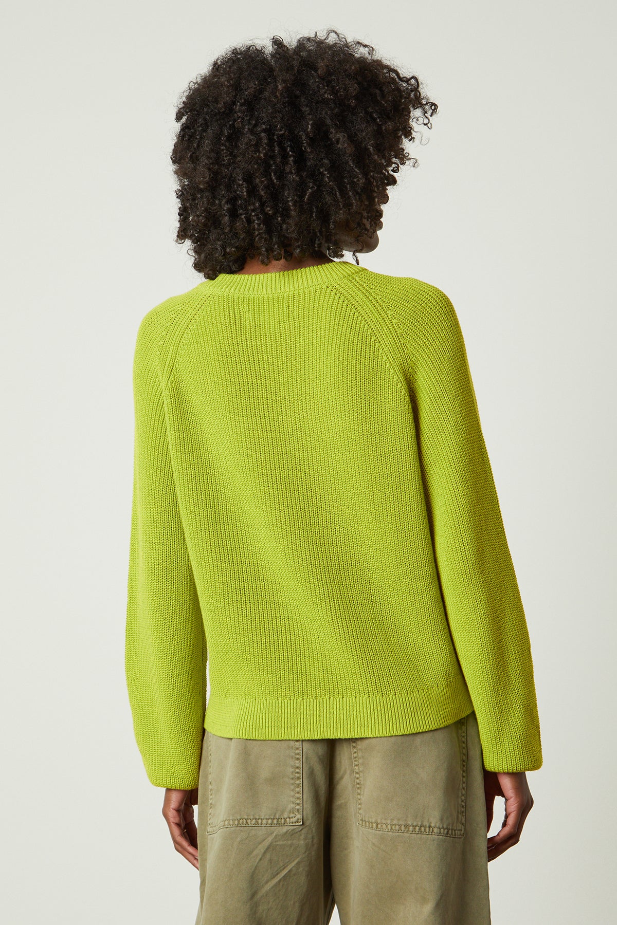   the back view of a woman wearing a Velvet by Graham & Spencer LINAH CREW NECK SWEATER. 