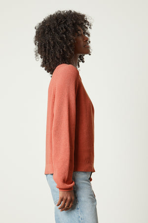 The back view of a woman wearing the Velvet by Graham & Spencer LINAH CREW NECK SWEATER and jeans.