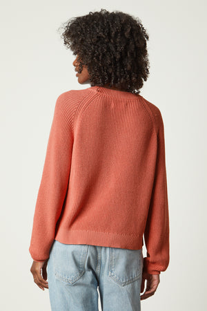 the back view of a woman wearing a Velvet by Graham & Spencer LINAH CREW NECK SWEATER and jeans.