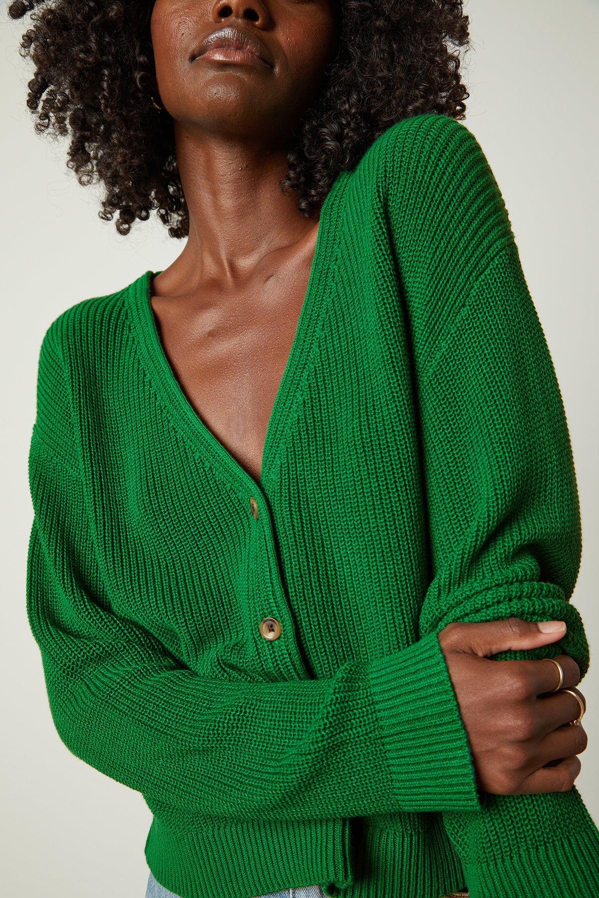   a woman wearing a green Velvet by Graham & Spencer YASMINE BUTTON FRONT CARDIGAN. 