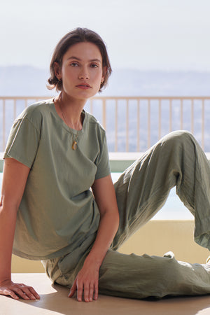 a woman sitting on the edge of a pool wearing Velvet by Jenny Graham's PICO PANT and a t-shirt