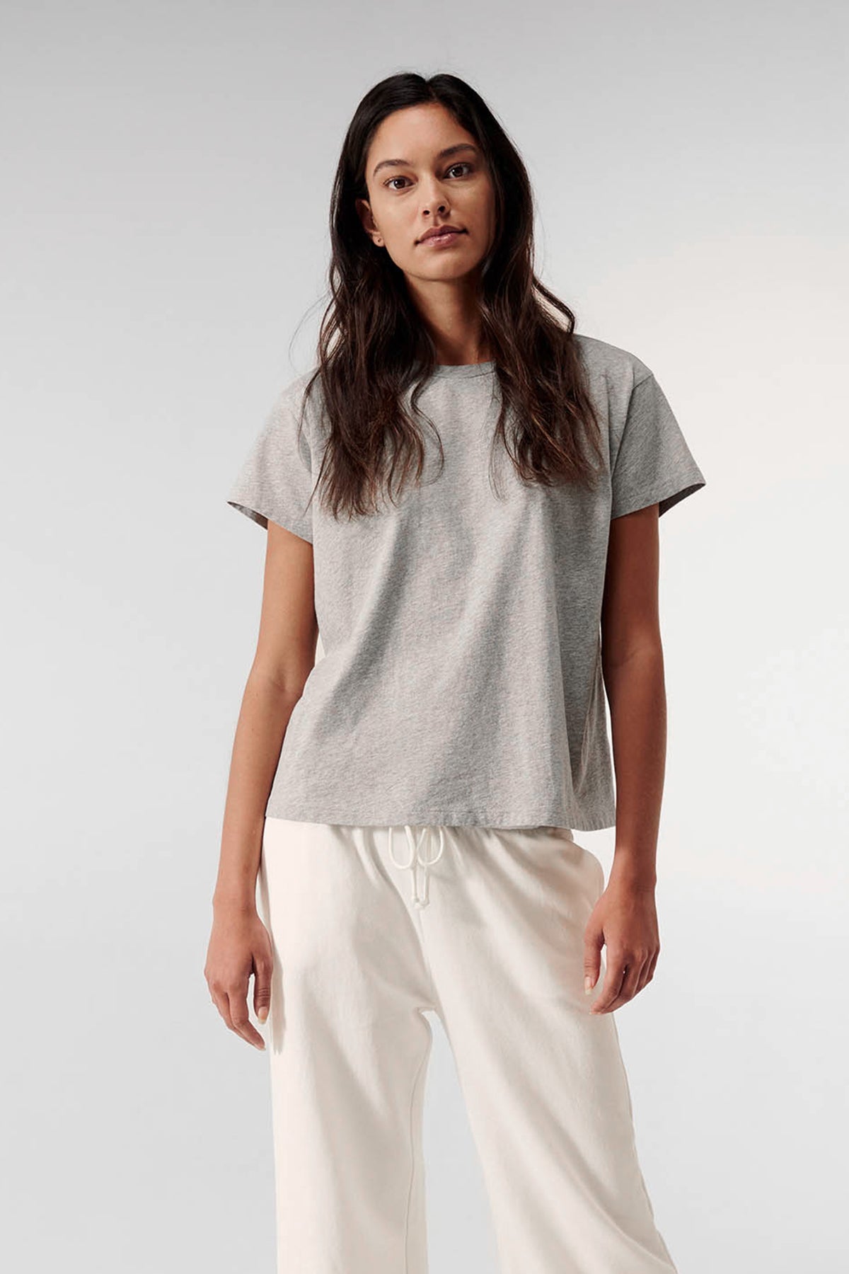   a woman wearing a Velvet by Jenny Graham Topanga Tee and white pants. 