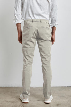 The back view of a man wearing Velvet by Graham & Spencer's BROGAN COTTON TWILL PANT for work or the weekend.