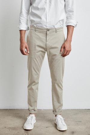A man wearing a white shirt and Velvet by Graham & Spencer BROGAN COTTON TWILL PANT for casual trousers.