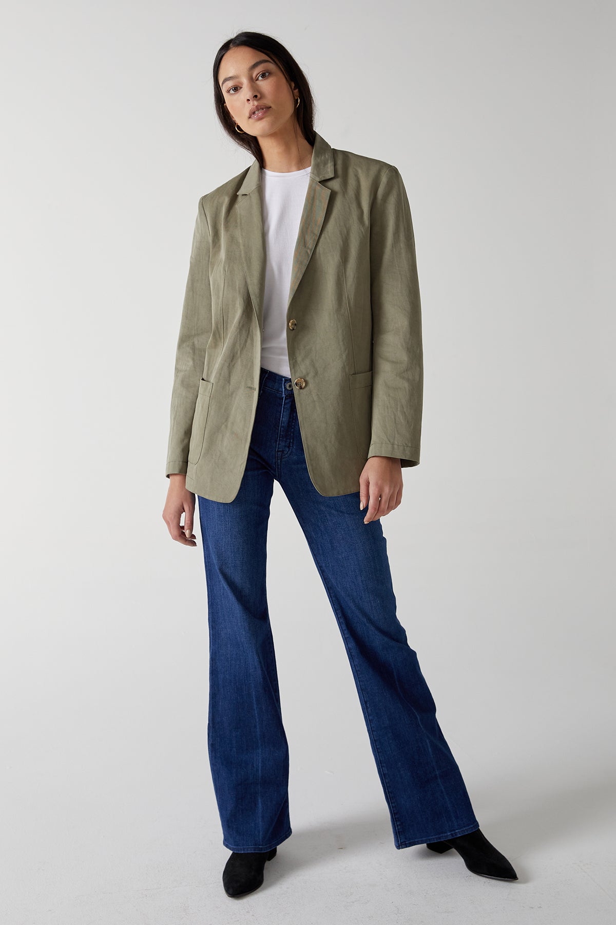   The model is wearing a ECHO BLAZER by Velvet by Jenny Graham and flared jeans. 