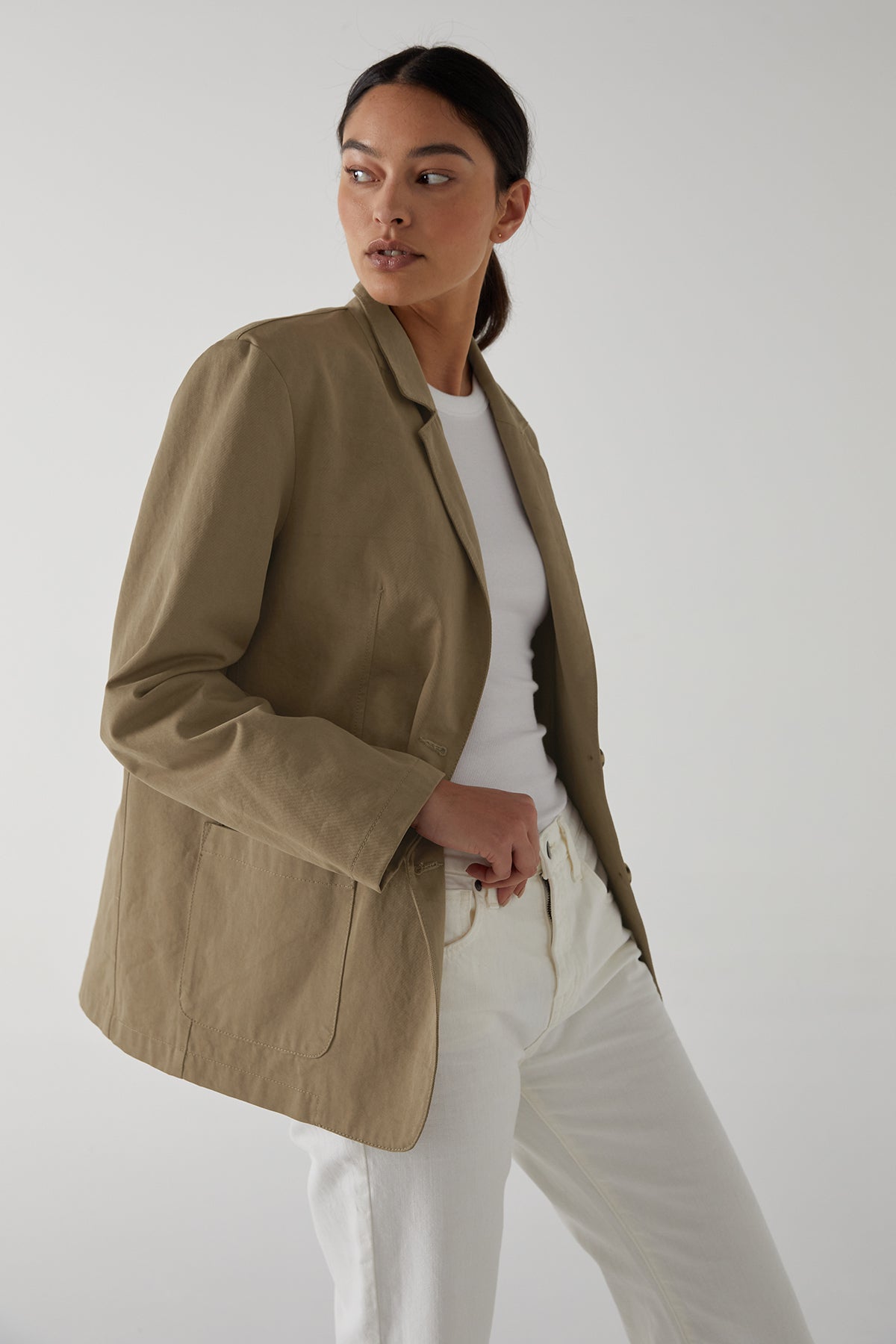   a woman wearing a Velvet by Jenny Graham ECHO BLAZER and white jeans. 