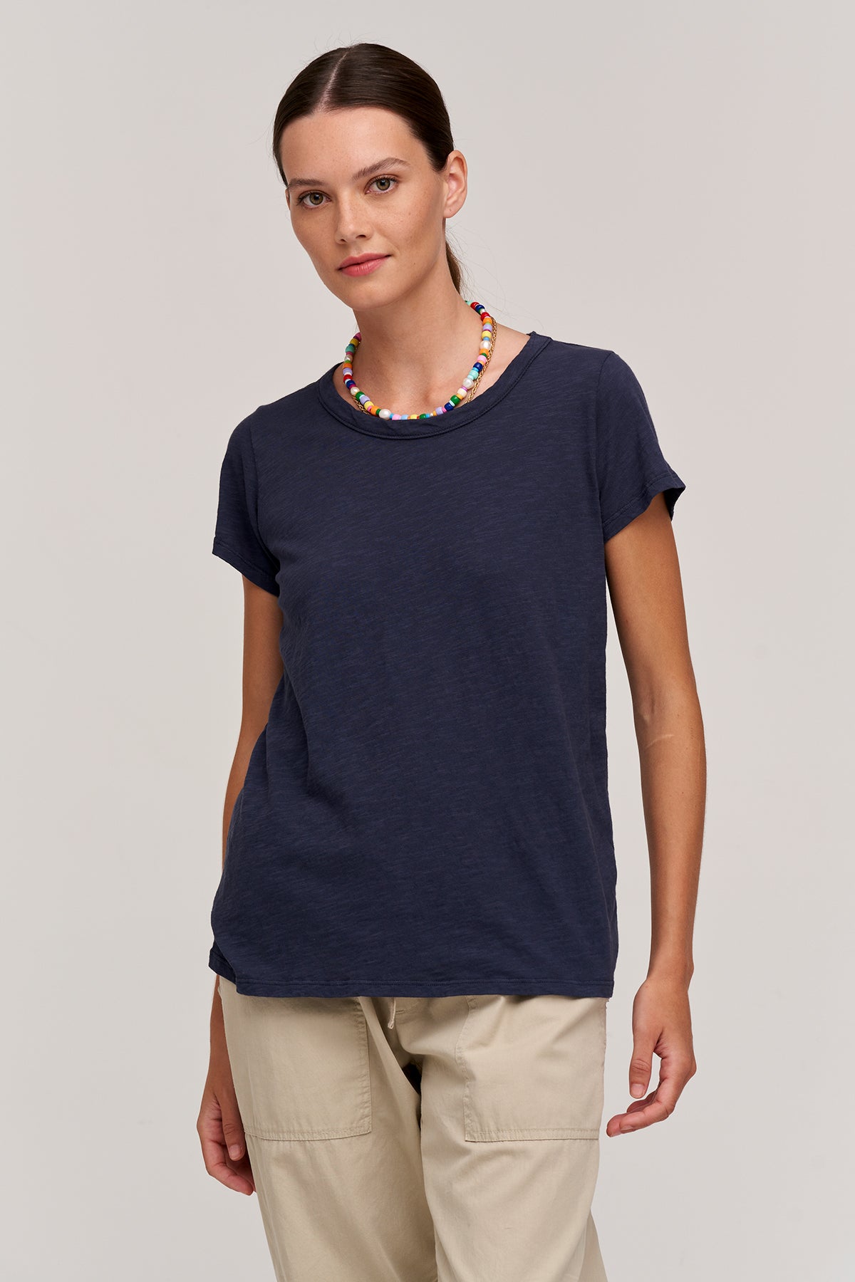   a woman wearing a navy TILLY ORIGINAL SLUB CREW NECK TEE by Velvet by Graham & Spencer and khaki pants. 