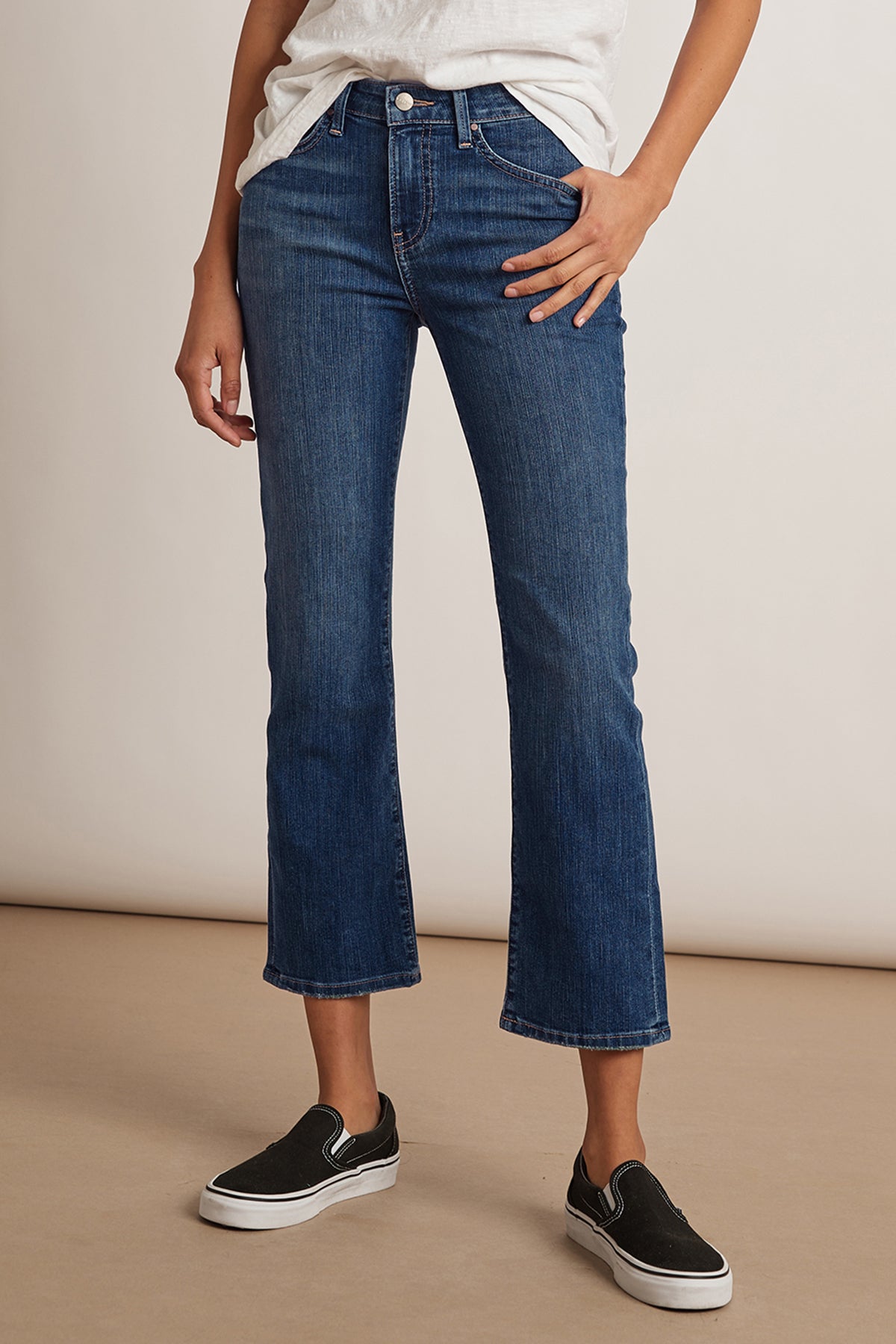   A woman wearing a pair of Velvet by Graham & Spencer KATE HIGH RISE CROP JEANS and a white t-shirt. 