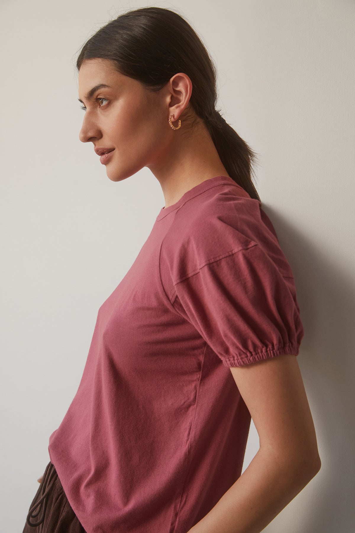   A woman wearing a classic raglan seam pink Velvet by Graham & Spencer VERNICE PUFF SLEEVE TEE crafted from the softest sueded jersey cotton knit. 