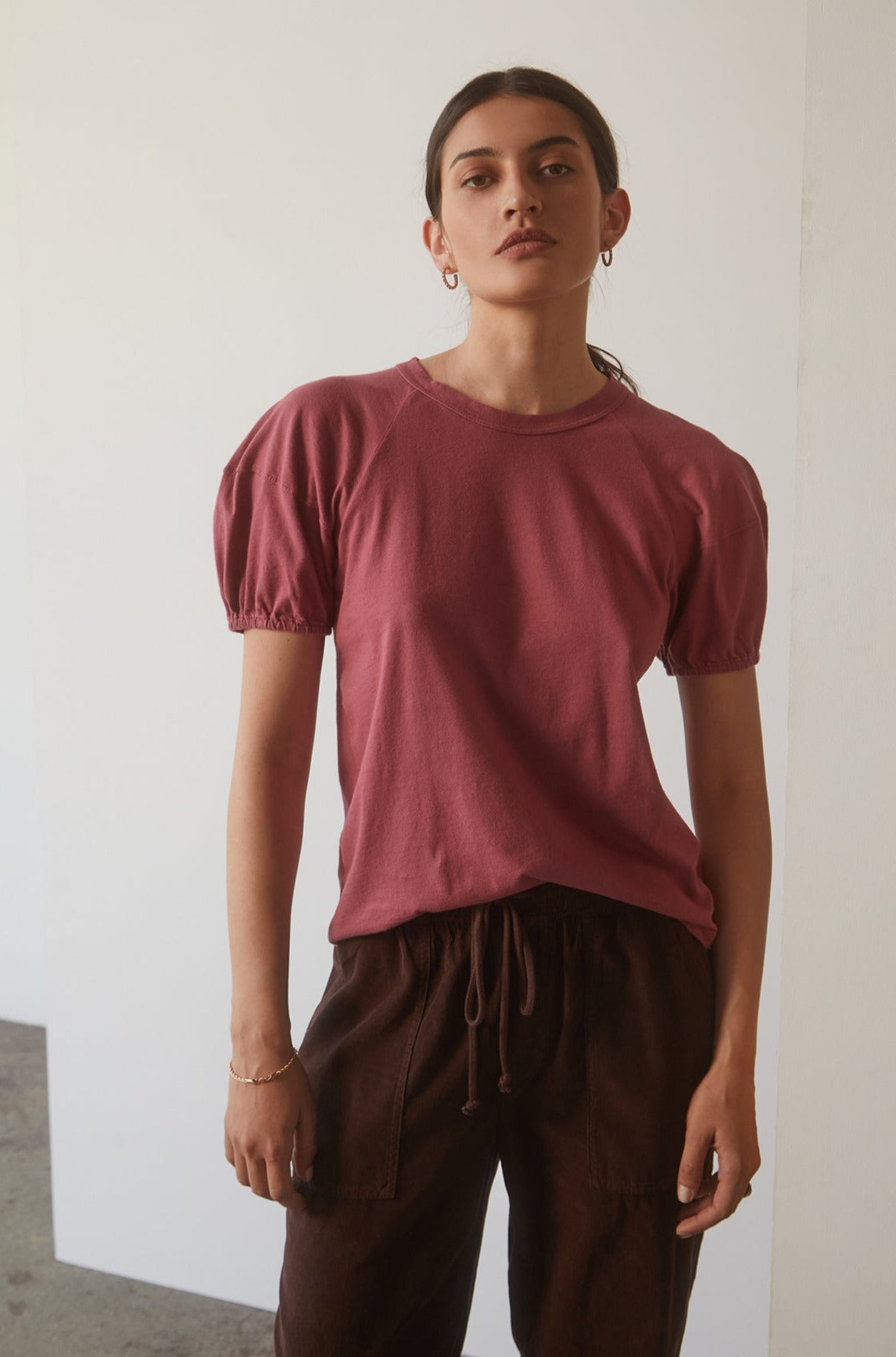   A woman wearing a pink Vernice Puff Sleeve Tee made from the softest sueded jersey cotton knit. (Brand: Velvet by Graham & Spencer) 