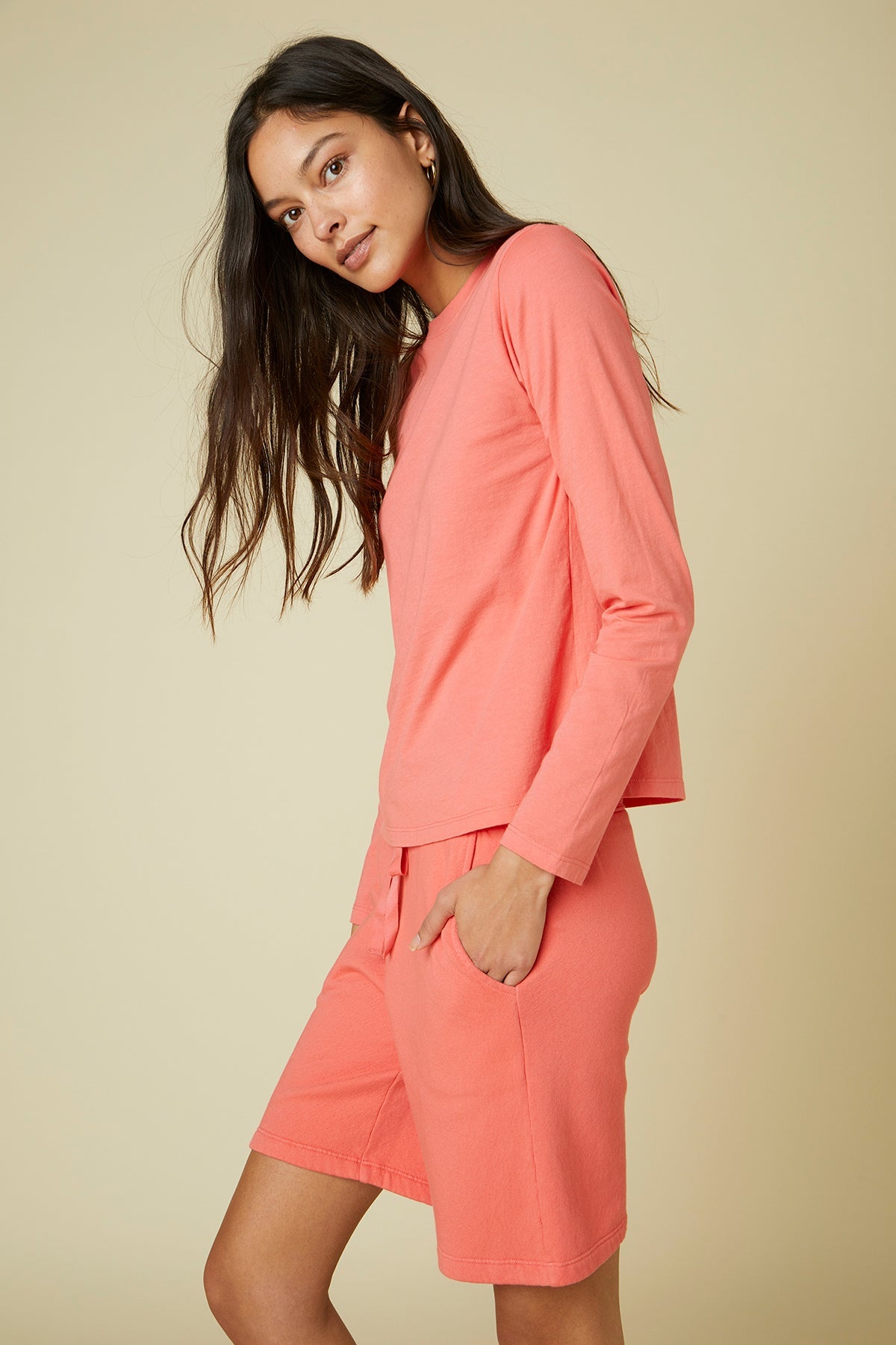   The model is wearing a pink long-sleeved Velvet by Jenny Graham pyjama top and shorts. 