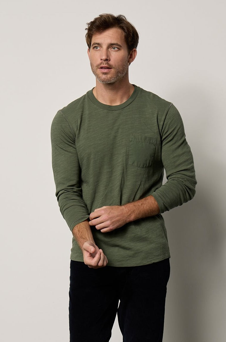 Victor Crew Neck Long Sleeve tee in palm green with black denim and black Converse full length front-25854956077249