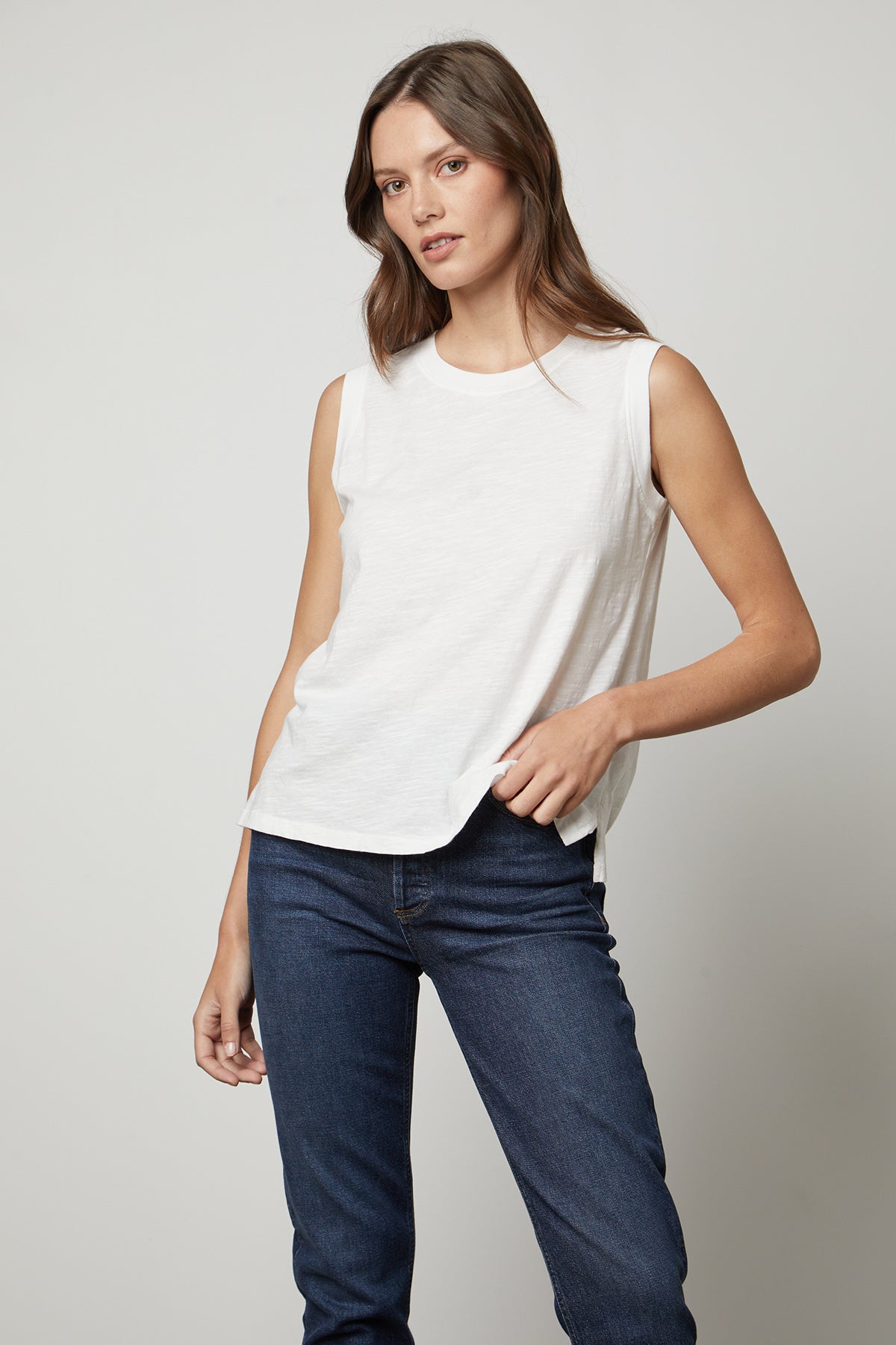   The model is wearing a Velvet by Graham & Spencer ELLEN VINTAGE SLUB TANK TOP and jeans. 