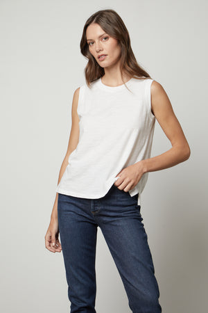 The model is wearing a Velvet by Graham & Spencer ELLEN VINTAGE SLUB TANK TOP and jeans.