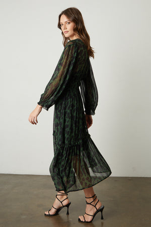 Kendra Printed Maxi Dress in green and black airbrush print with black sandals full length side