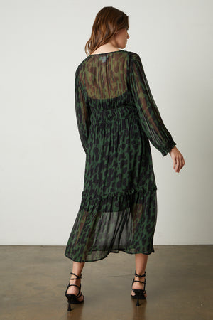 Kendra Printed Maxi Dress in green and black airbrush print with black sandals full length back