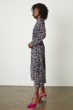 Kendra Printed Maxi Dress in calico print with hot pink heels full length side