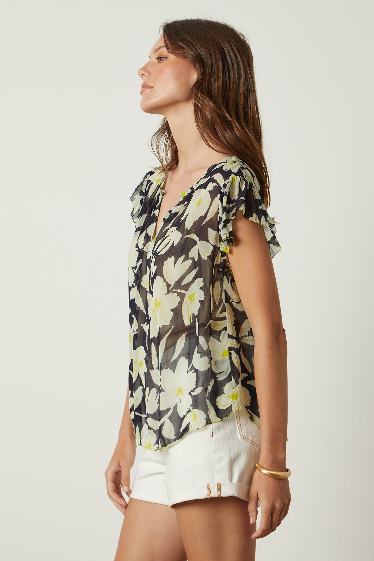   a woman wearing shorts and a LUCIA PRINTED TOP by Velvet by Graham & Spencer. 