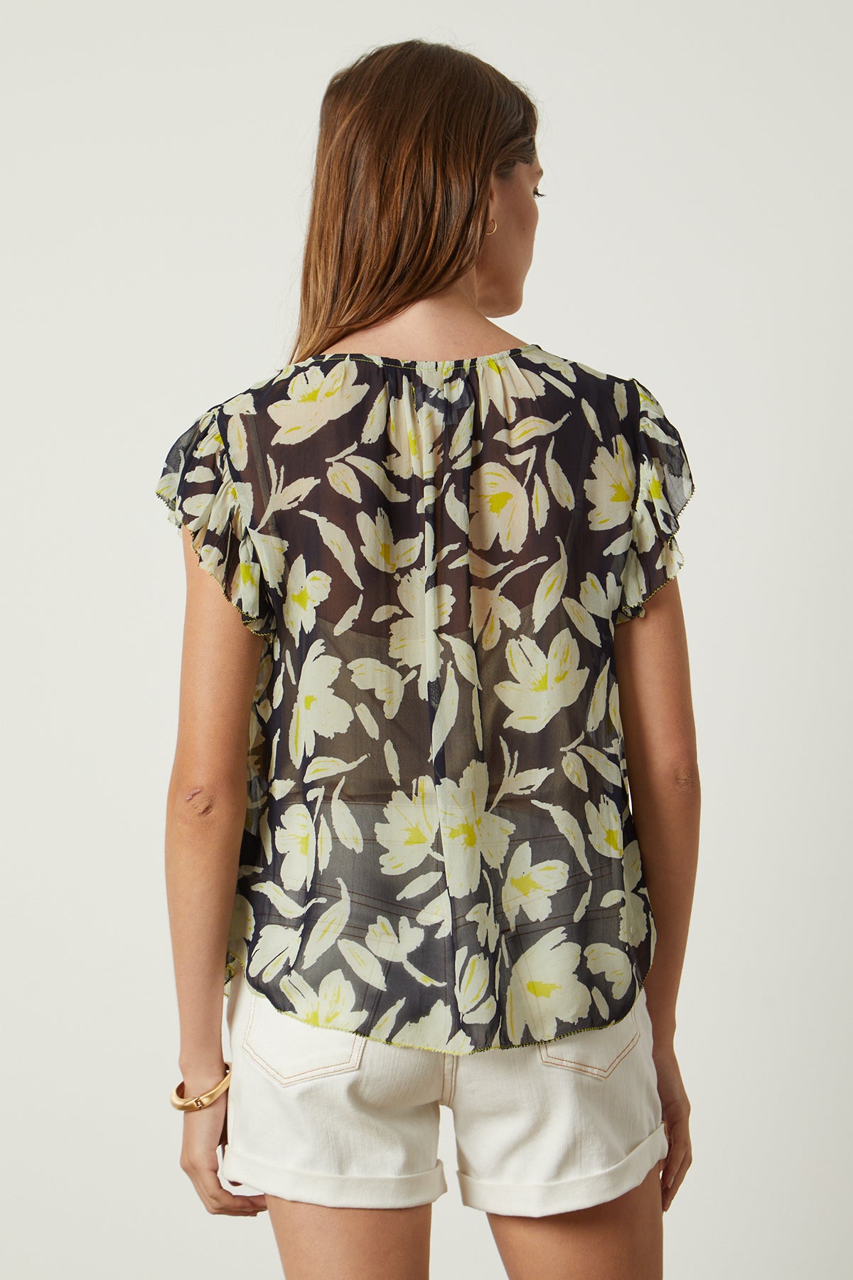 the back view of a woman wearing the Velvet by Graham & Spencer LUCIA PRINTED TOP with floral print.-26143082807489
