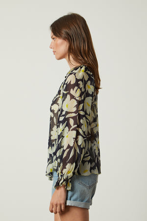 the back view of a woman wearing the Velvet by Graham & Spencer MILEY PRINTED TOP.