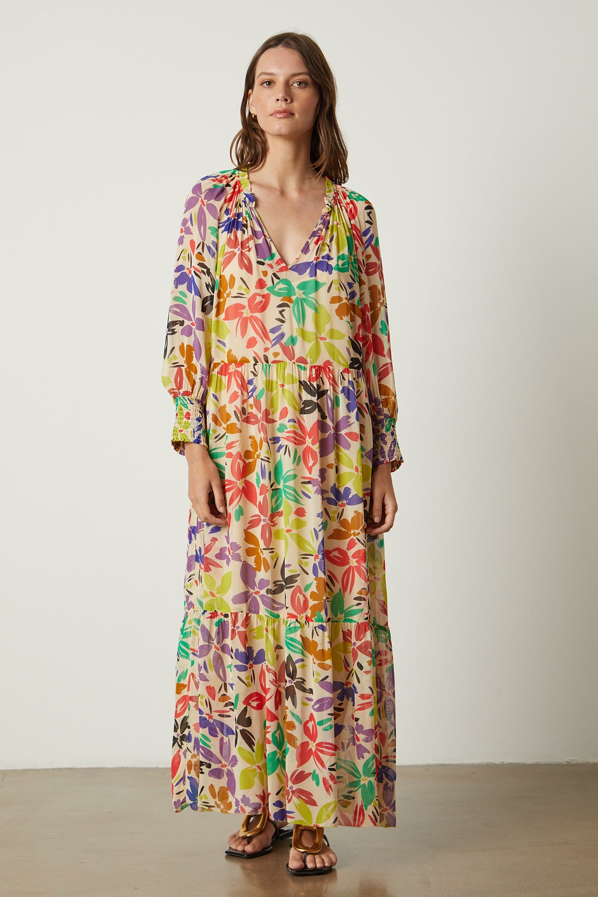   A woman wearing a SERENA PRINTED MAXI DRESS by Velvet by Graham & Spencer. 