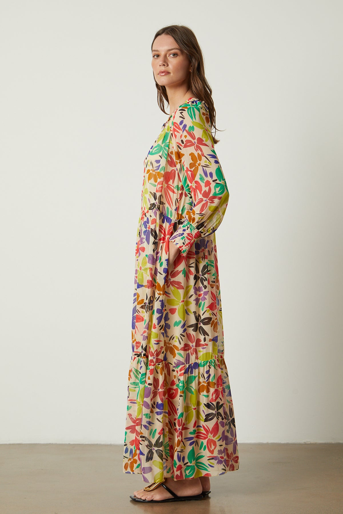 The model is wearing a SERENA PRINTED MAXI DRESS by Velvet by Graham & Spencer.-26022624723137