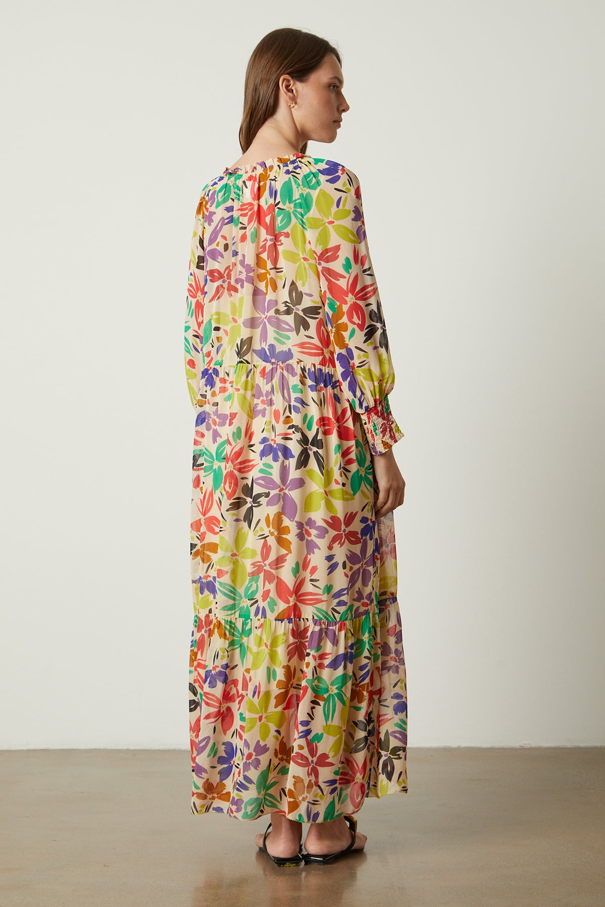   The back view of a woman wearing a Velvet by Graham & Spencer SERENA PRINTED MAXI DRESS. 