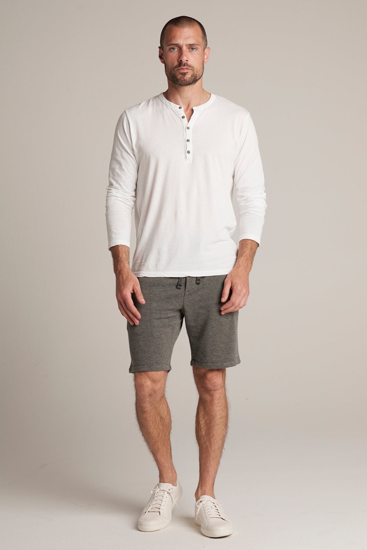   The man is wearing Velvet by Graham & Spencer shorts with an ATLAS CHARCOAL LUXE FLEECE DRAWSTRING SHORT design. 