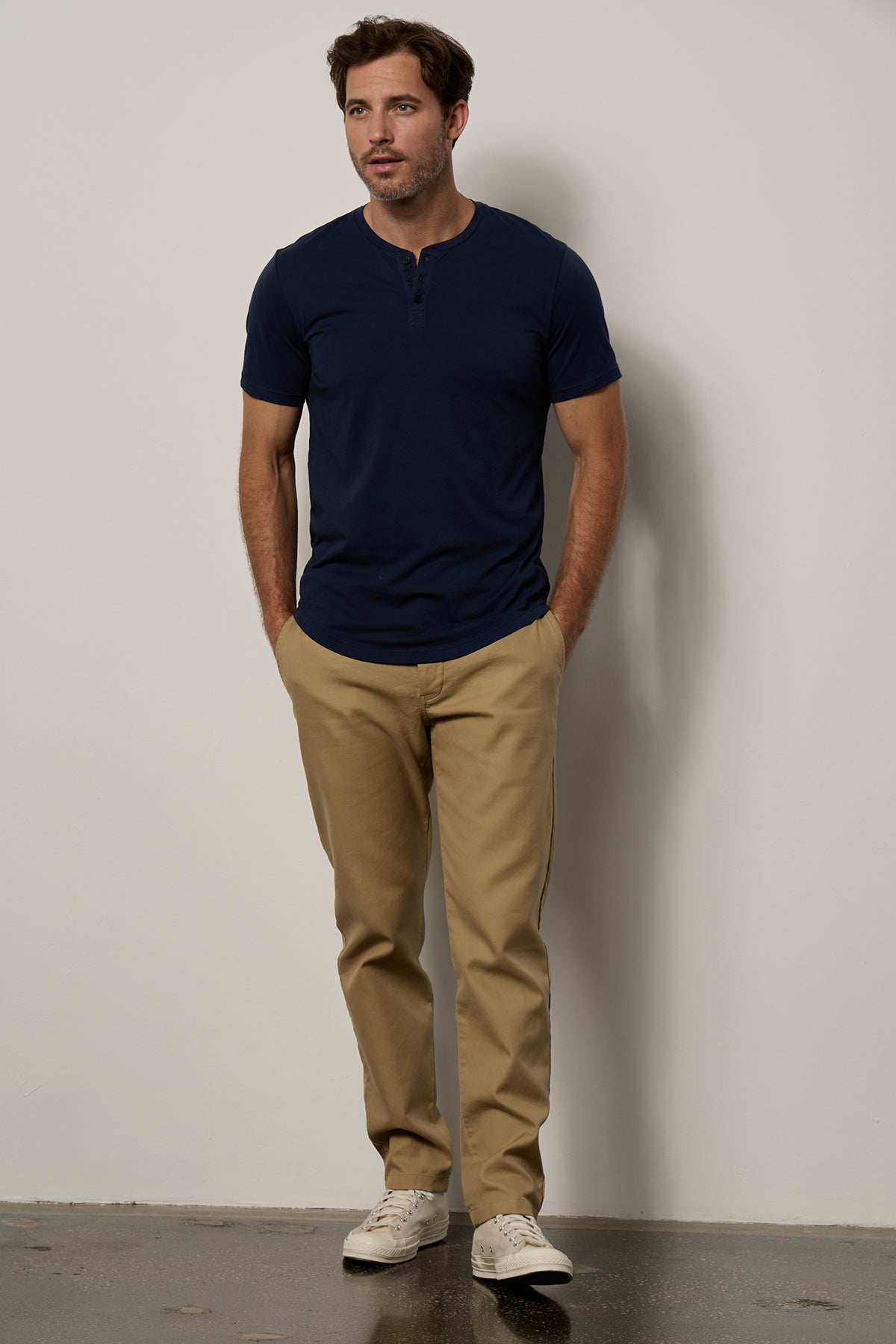   Fulton Short Sleeve Henley in midnight with Aiden pant in khaki full length front with Converse 