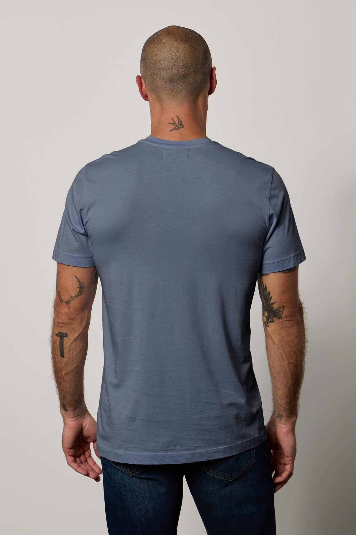   The Velvet by Graham & Spencer Howard Whisper Classic Crew Neck Tee offers a vintage-feel softness from the back view of a man. 