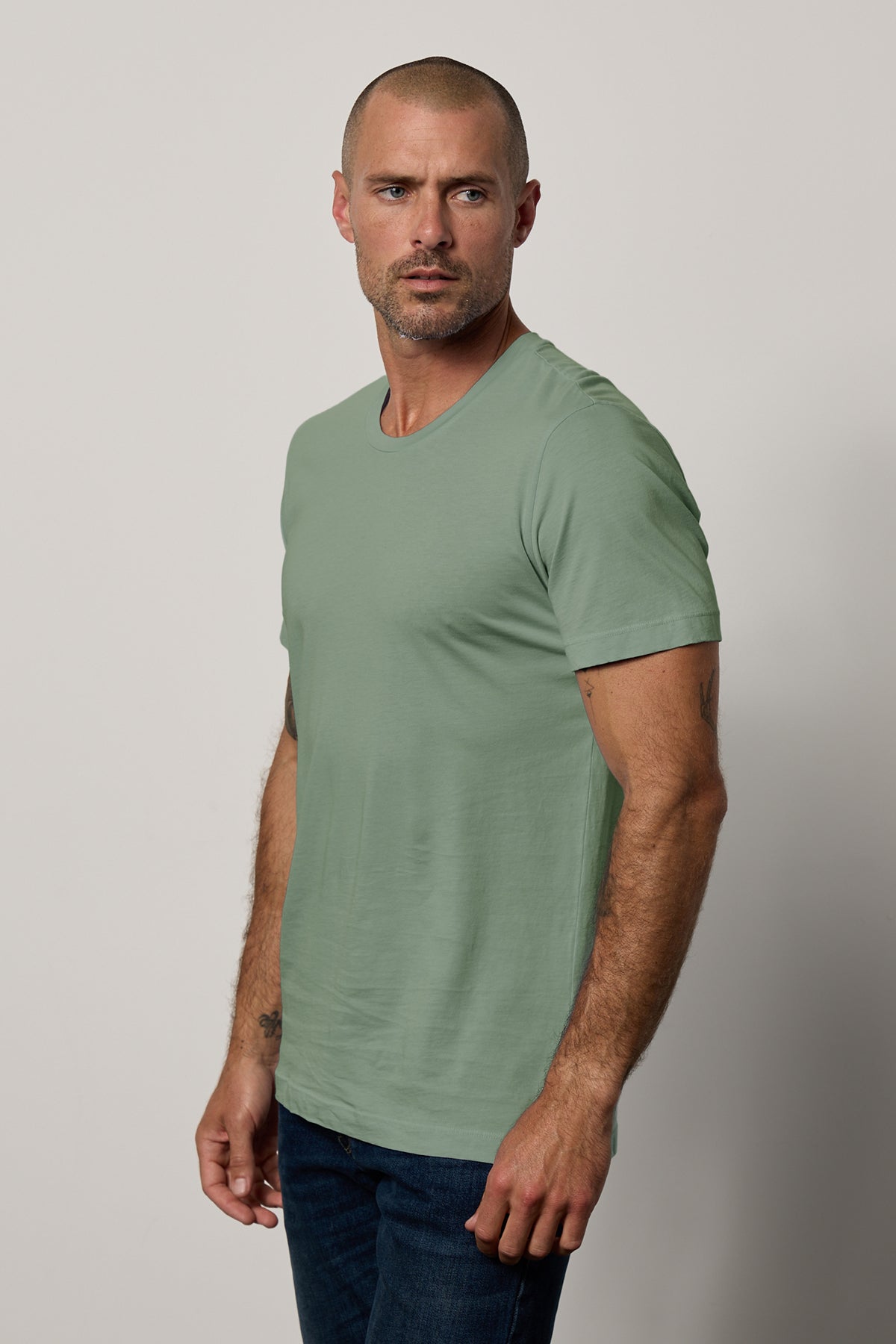   A man wearing jeans and a lightweight cotton Velvet by Graham & Spencer HOWARD WHISPER CLASSIC CREW NECK TEE. 