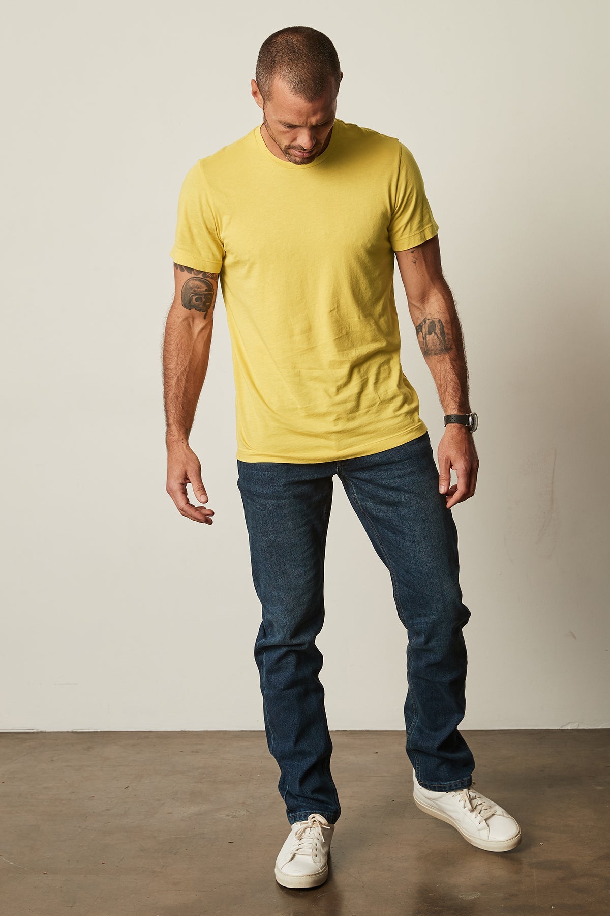   A man wearing a Velvet by Graham & Spencer HOWARD WHISPER CLASSIC CREW NECK TEE and jeans. 
