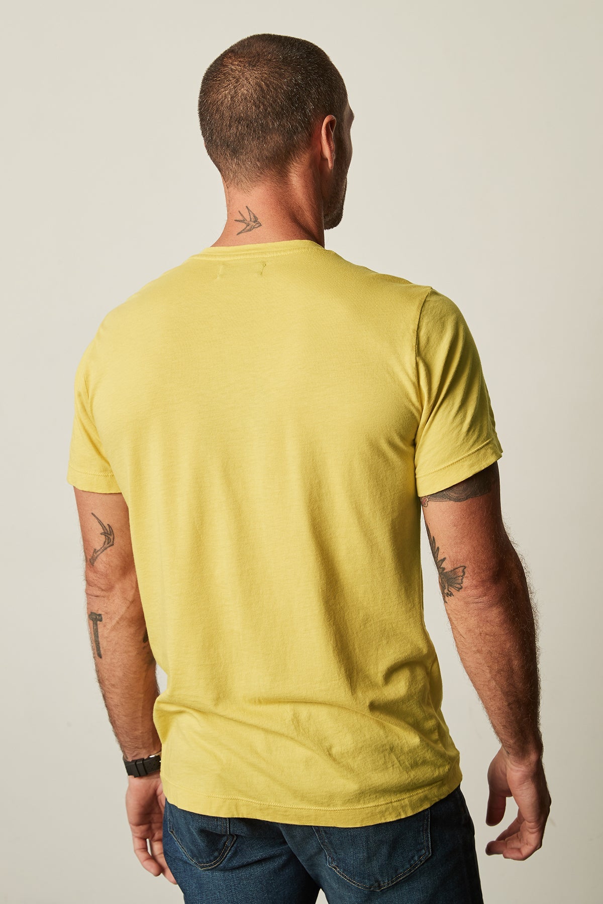 The back view of a man wearing a Velvet by Graham & Spencer HOWARD WHISPER CLASSIC CREW NECK TEE.-25793660682433