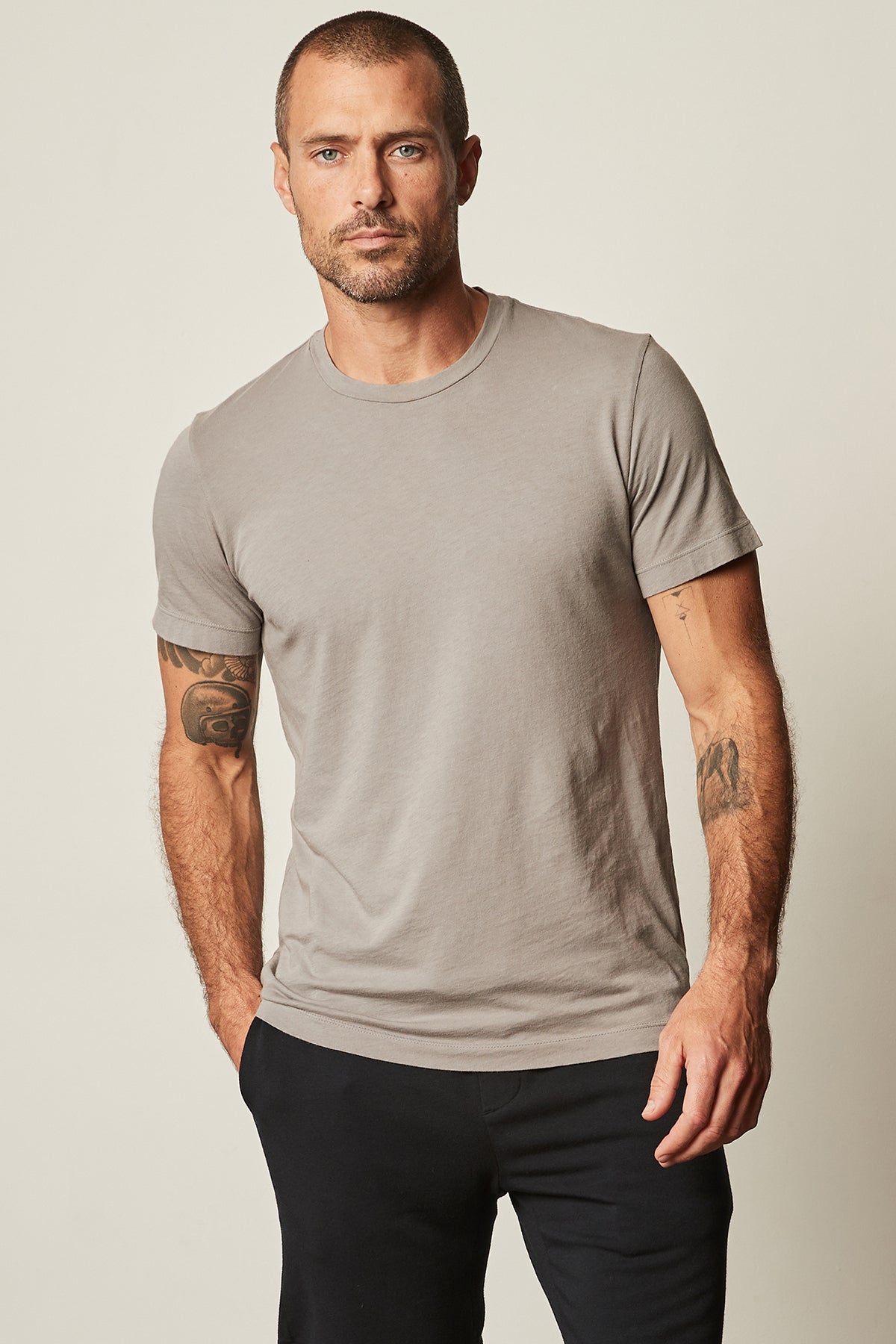   A man wearing a Velvet by Graham & Spencer HOWARD WHISPER CLASSIC CREW NECK TEE made from lightweight cotton knit fabric. 