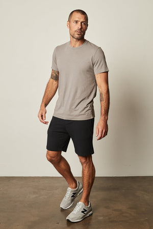 The man is wearing a Velvet by Graham & Spencer lightweight cotton knit grey HOWARD WHISPER CLASSIC CREW NECK TEE.