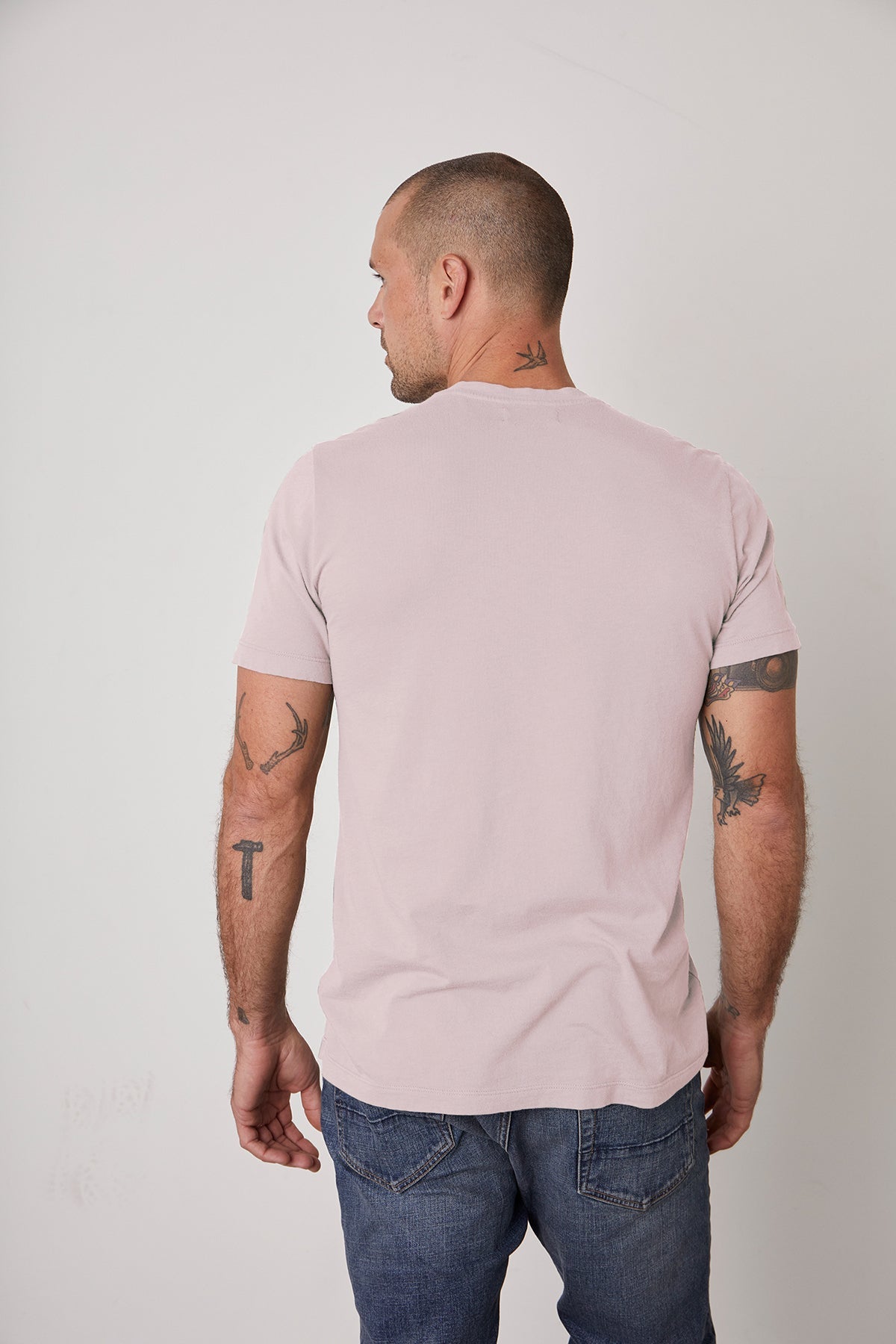   The back of a man wearing a Velvet by Graham & Spencer HOWARD WHISPER CLASSIC CREW NECK TEE with a vintage-feel softness. 