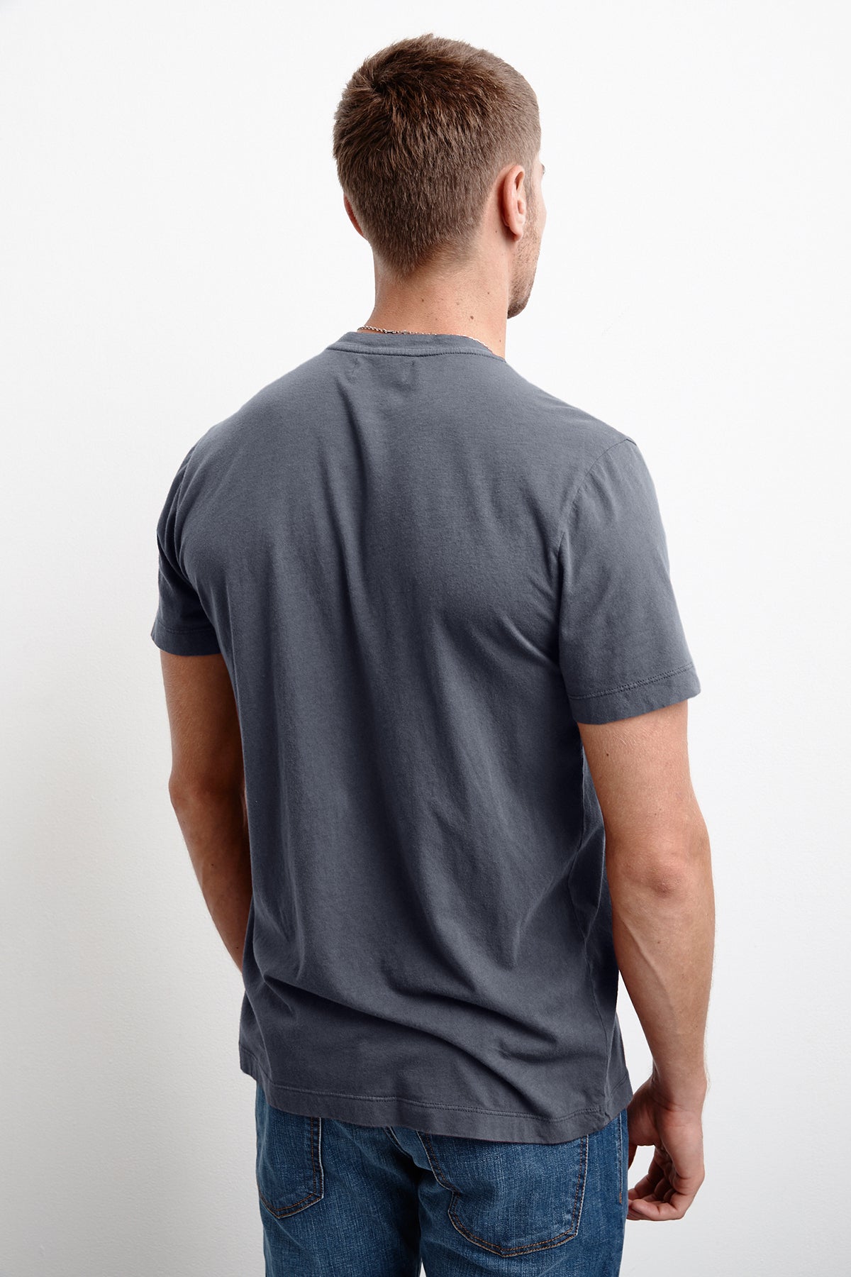 The inimitable back view of a man wearing HOWARD WHISPER CLASSIC CREW NECK TEE jeans and a grey t-shirt from Velvet by Graham & Spencer.-1711198896209
